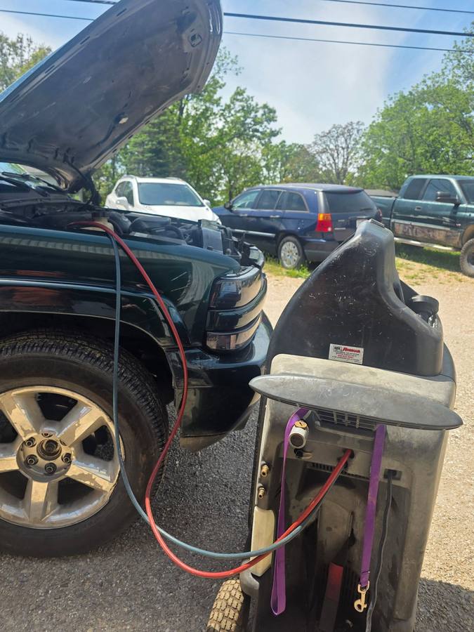 Truck with hood open and A/C service machine hooked up